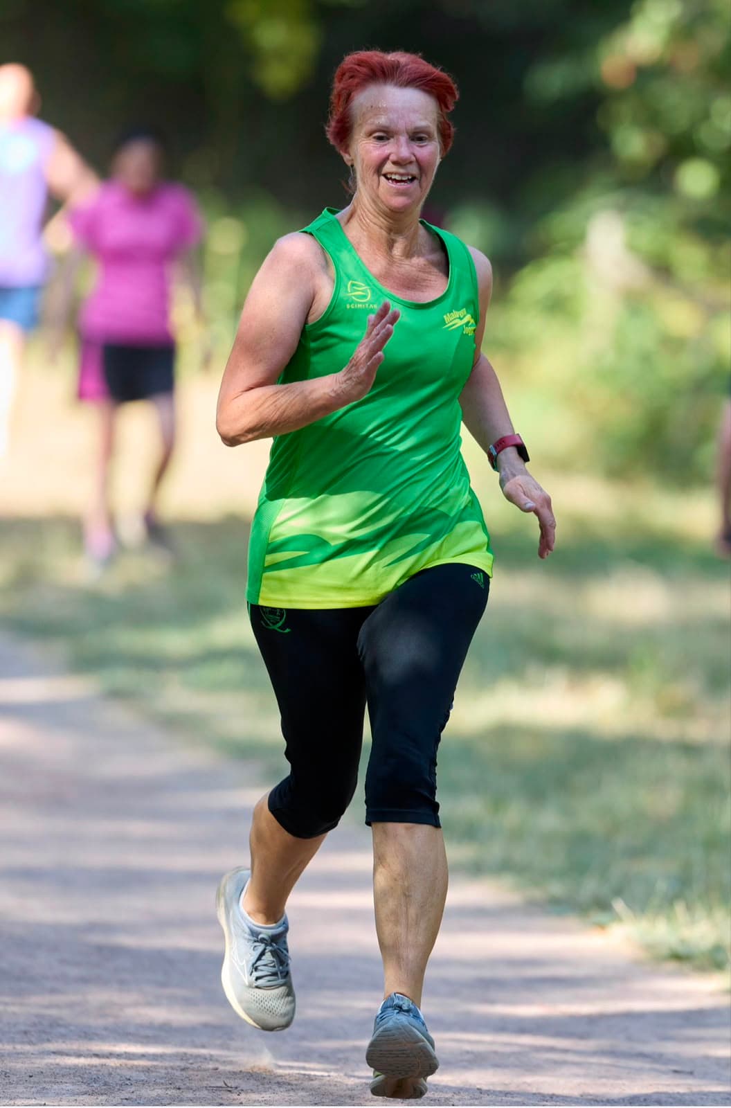 A member sprinting for the line with a huge smile
