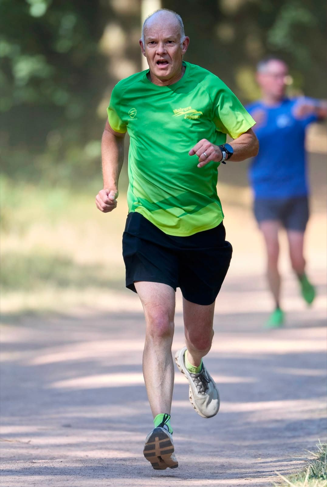 A Malvern Joggers member mid-race on a woodland trail