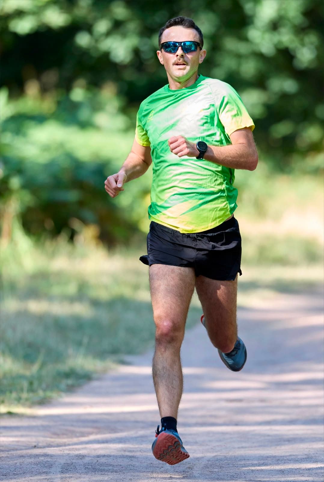 A member in club kit, both feet off the ground mid-stride